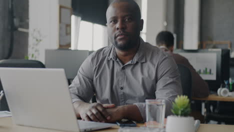 man working at a laptop in an office