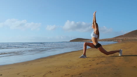 woman stretching legs and hamstrings doing standing forward bend yoga stretch pose on beach. fitness woman relaxing and practising sport and yoga on.