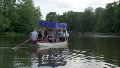 Boats full of tourists in Lazienki Park in Warsaw.