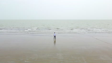 unhappy lone man contemplating in front of a serene beach in bangladesh