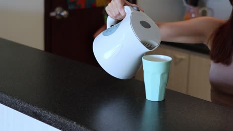 sequence of pouring a drink from a kettle into a cup