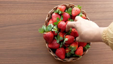 ripe red strawberries in a bowl on table