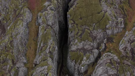 cinematic aerial of popular crevasse lambafell in iceland, tourist attraction