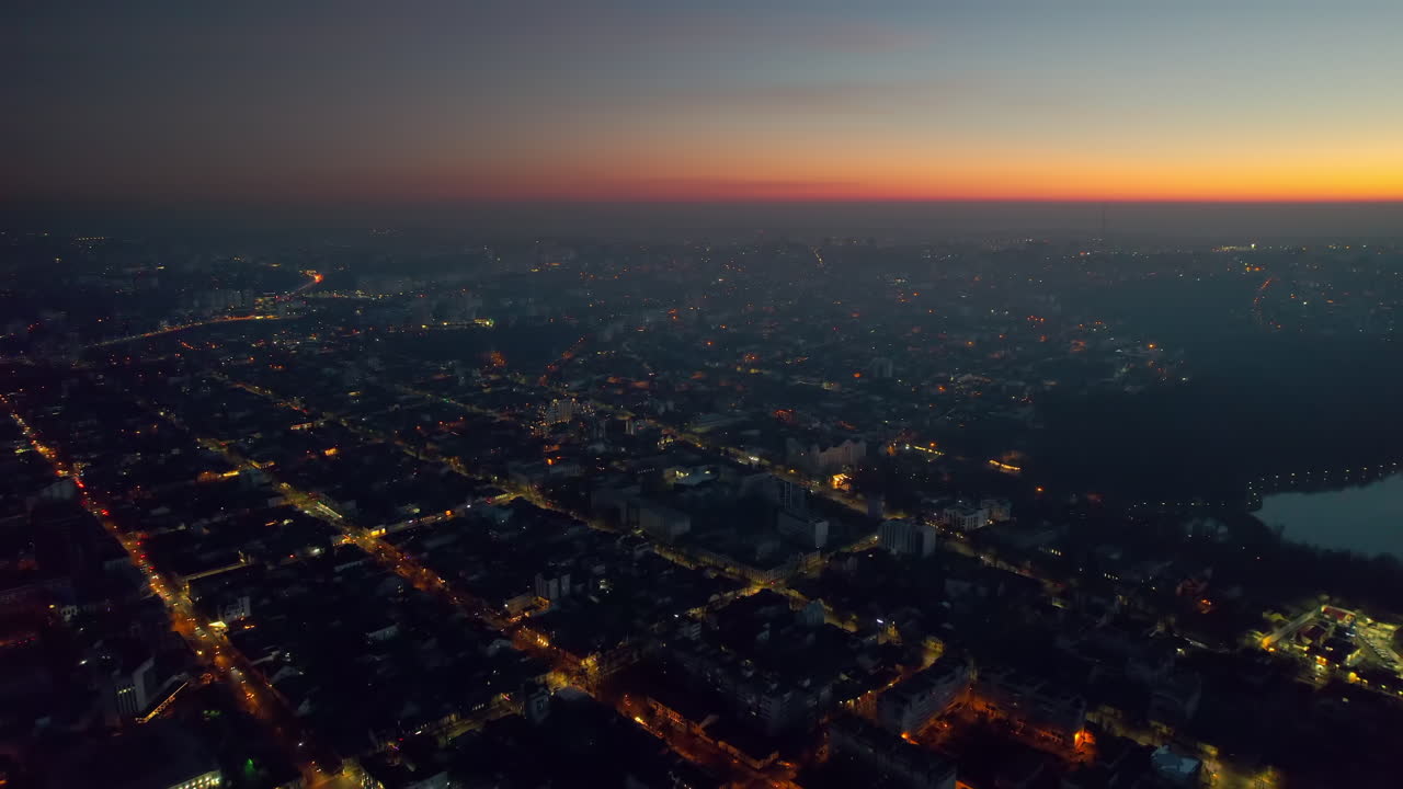 Aerial drone view of Chisinau at sunset, Moldova. View of city centre with multiple buildings, roads, illumination