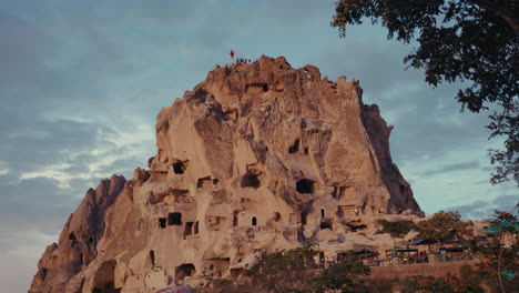 ancient cave dwellings in cappadocia at sunset