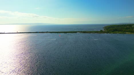 Panoramic-drone-shot-of-Punta-Trettu-kite-beach,-Sardinia,-Italy