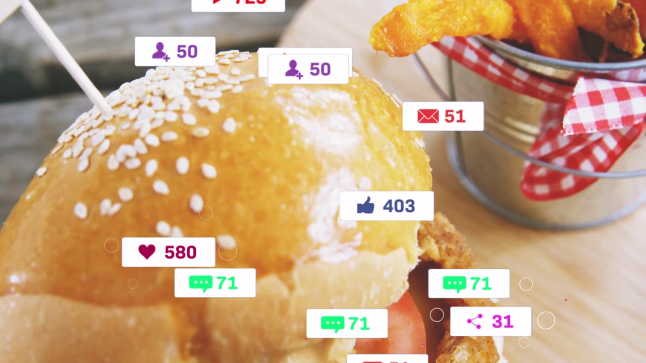Stacked burger attracting social badges after alert ping, revealing fries while showing engagement