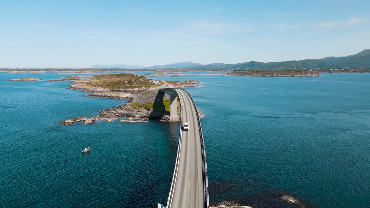 Aerial view of a car crossing Storseisundet bridge on Atlantic Road also known as &rdquo;The Road in the Ocean&rdquo; in Norway