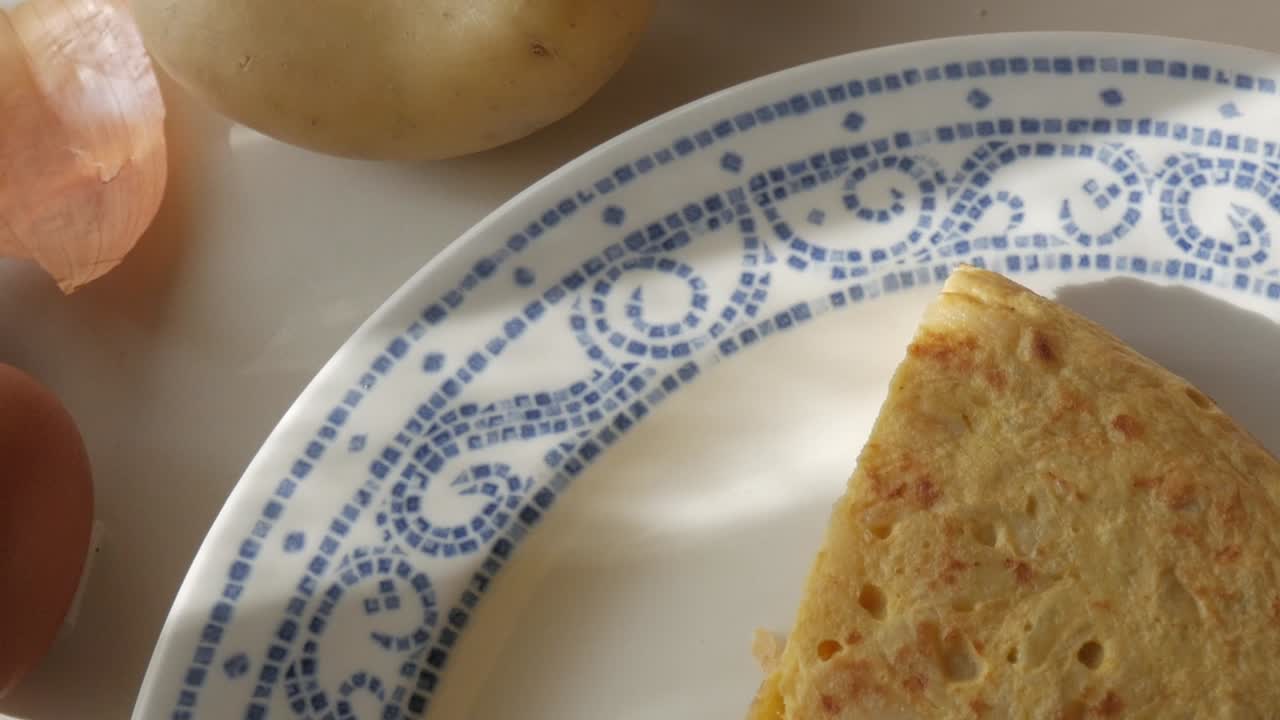 Spanish potato omelette, close-up of fresh eggs, onions, and potatoes ready for cooking
