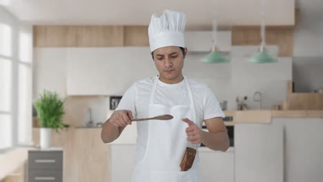 happy indian professional chef tasting good food