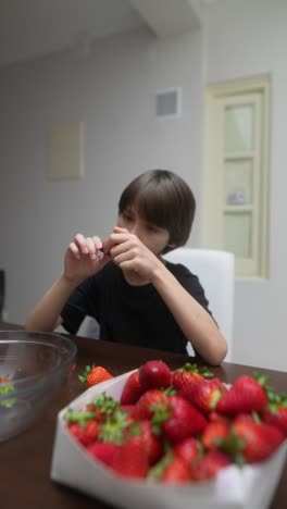 boy eating strawberries