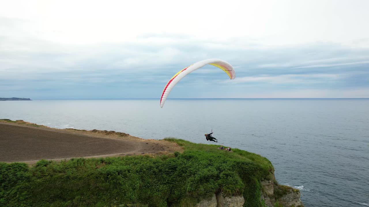 Unrecognizable Skydiver With Parachute Flies Against Blue Sky