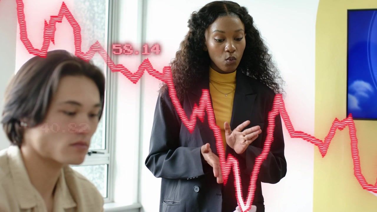 Woman speaking and gesturing, causing red market chart overlay spiking addressing peer on risk