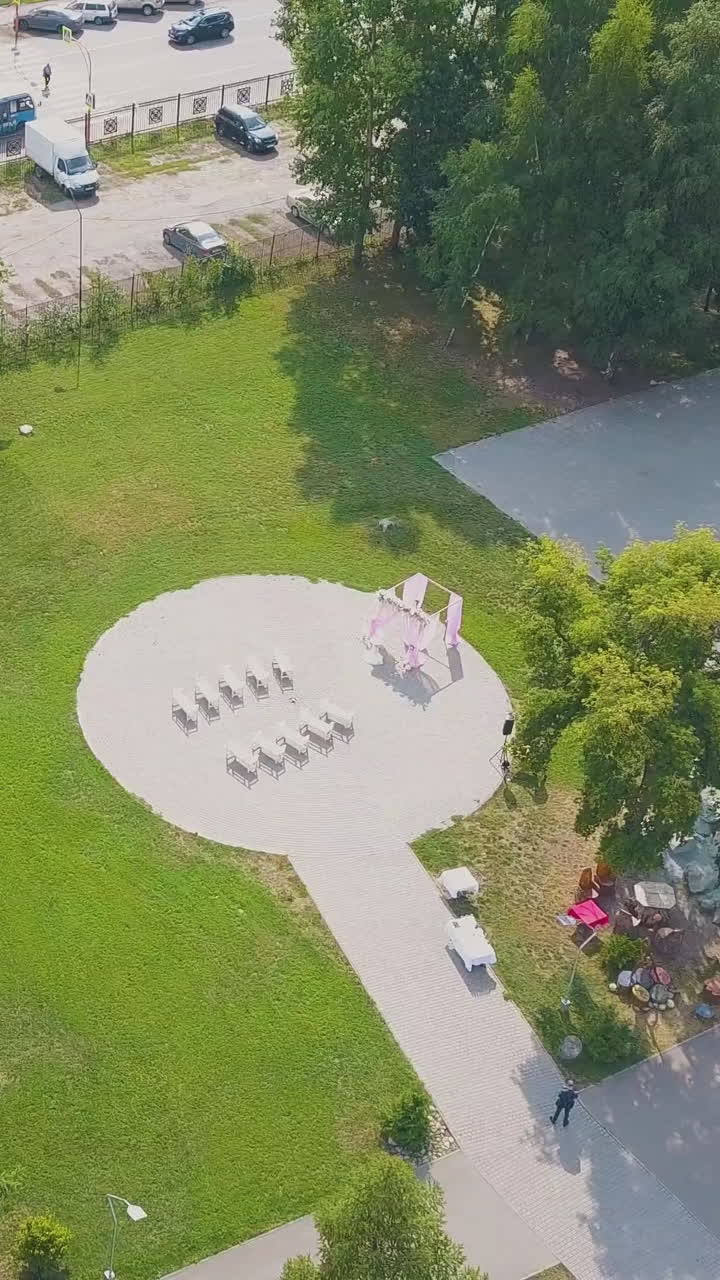 modern wedding ceremony site with white benches in picturesque green park on sunny autumn day bird eye view