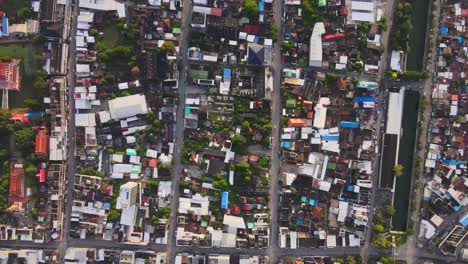 aerial: top-down static drone shot high above residential blocks separated by streets in densely populated nakhon ratchasima town in korat province, thailand