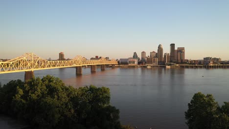 louisville, kentucky skyline with bridge and trees with drone video moving down