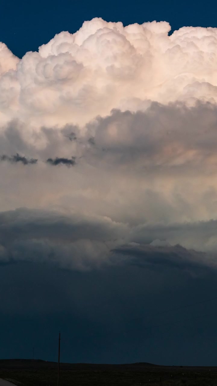 Thunderstorm clouds light up from within with frequent flashes of lightning