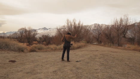 drone operator lifts up drone with prey for a modern falconry training