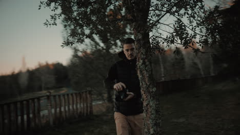 handsome passionate male photography enthusiast capturing photos of nature