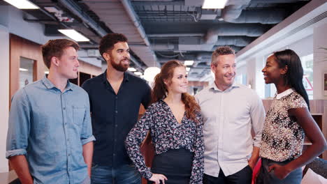 portrait of casually dressed businessmen and businesswomen in modern office space shot in slow motion