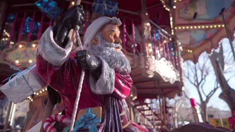 christmas statue of santa claus on a merry-go-round, colourful carousel on a sunny day