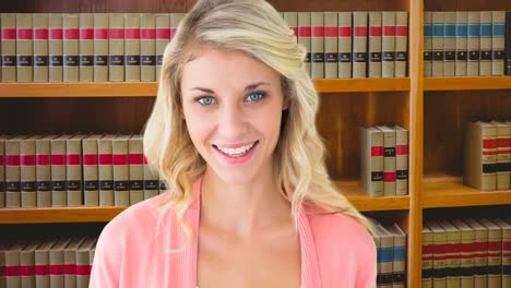 animation of happy caucasian woman reading book over library