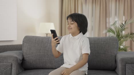 Cute-Indian-boy-scrolling-through-phone