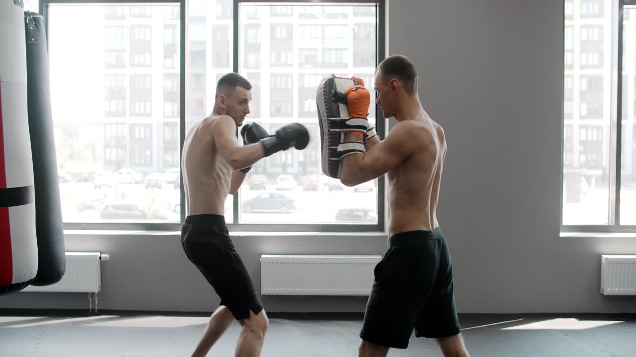 Men Training Boxing/Kickboxing in Gym
