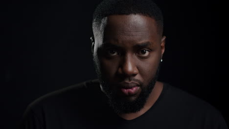 handsome african american guy staring at lense. guy looking at camera in studio