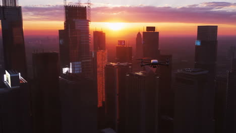 drone flying over a cityscape at sunset