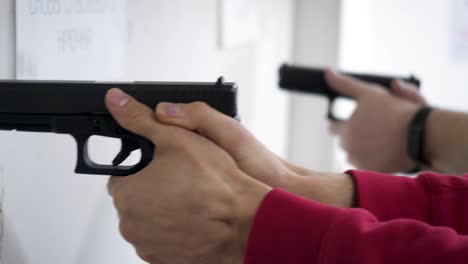 people practicing with handguns at a shooting range