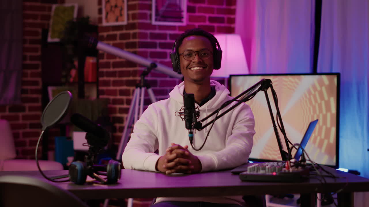 Portrait of african american podcaster adjusting digital audio mixer while talking live to audience