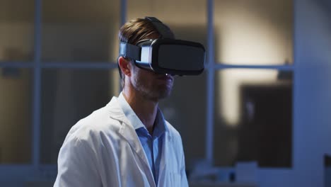 Caucasian-male-doctor-wearing-vr-headset-using-virtual-interface