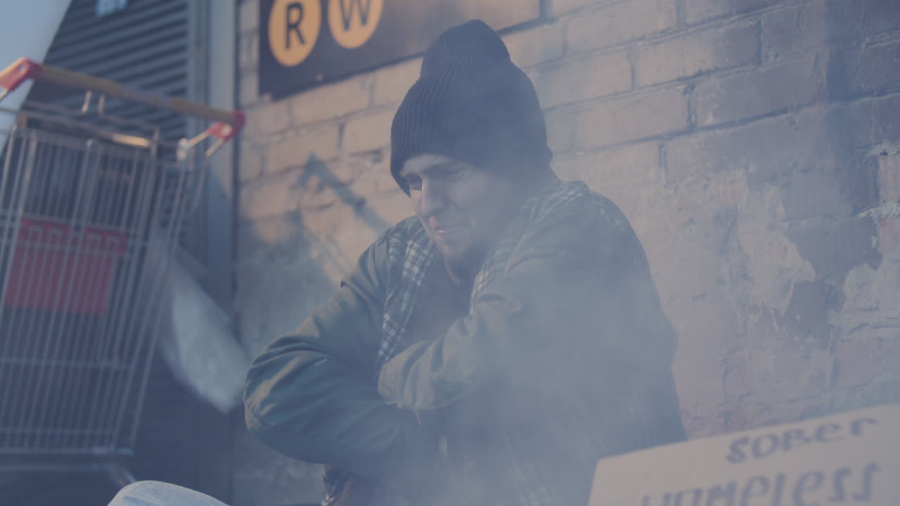 Homeless Man Shivering from Cold and Coughing as Begging on Street