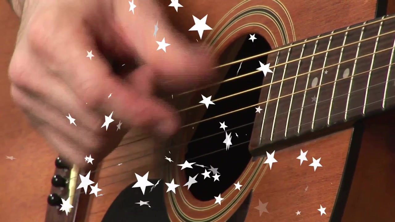 Una mano entra nell'inquadratura strimpellando le corde per un ritmo cadenzato con stelle tremolanti.