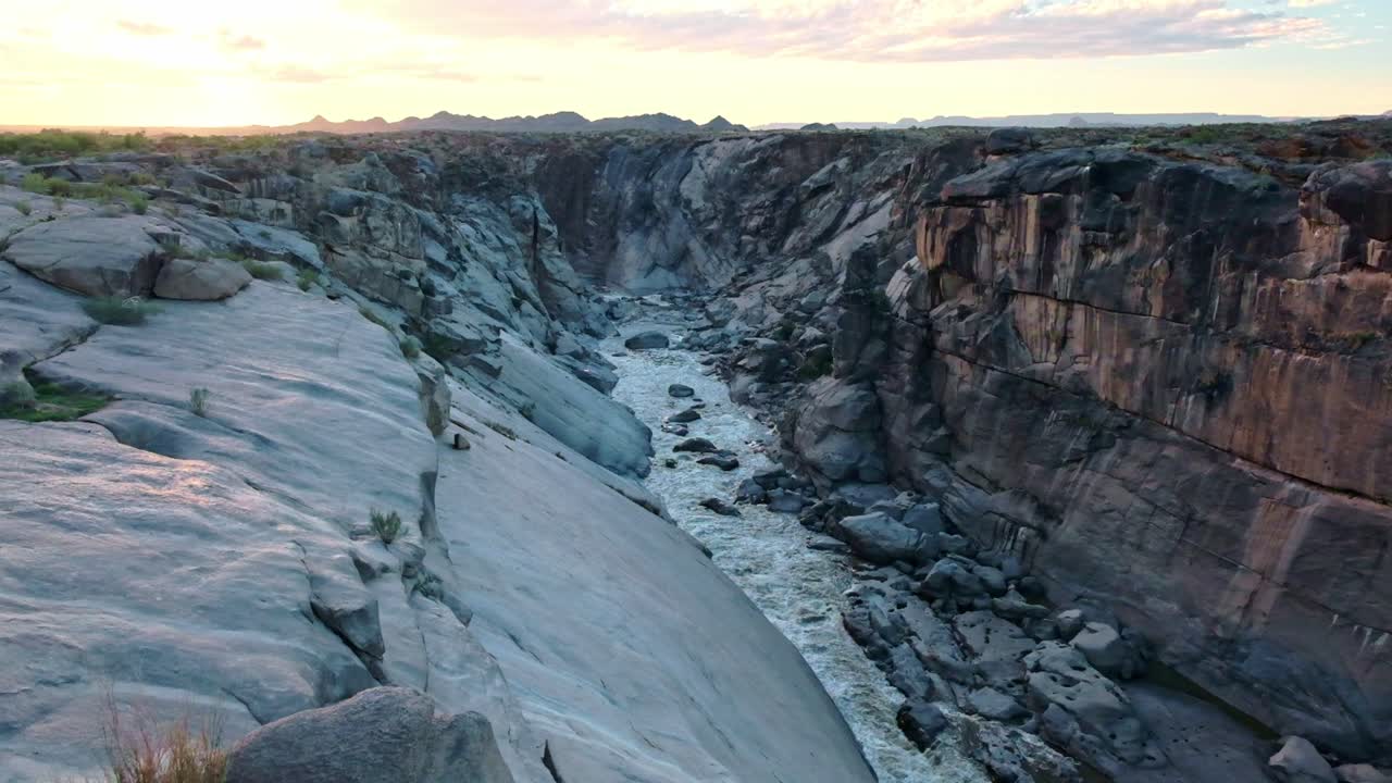 Sunset falls over the orange river canyon at Augrabis waterfalls in the Northern Cape of South Africa