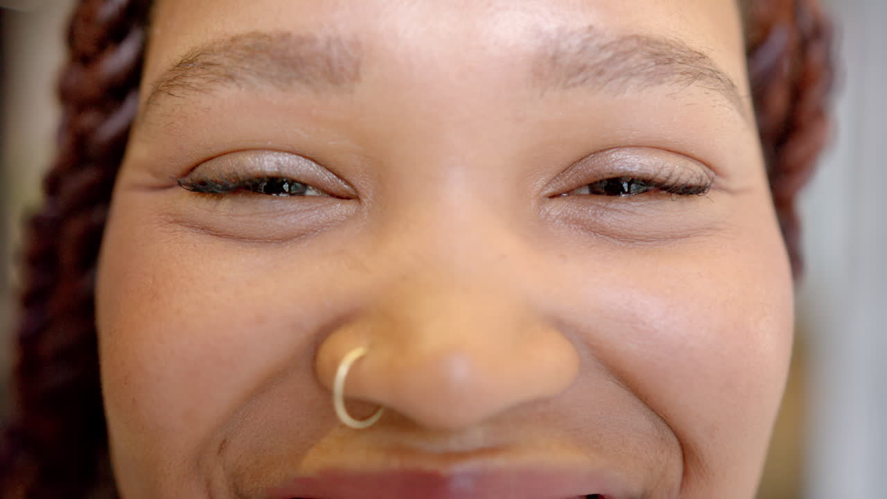 Smiling woman with nose ring, close-up of face, showing happiness and joy