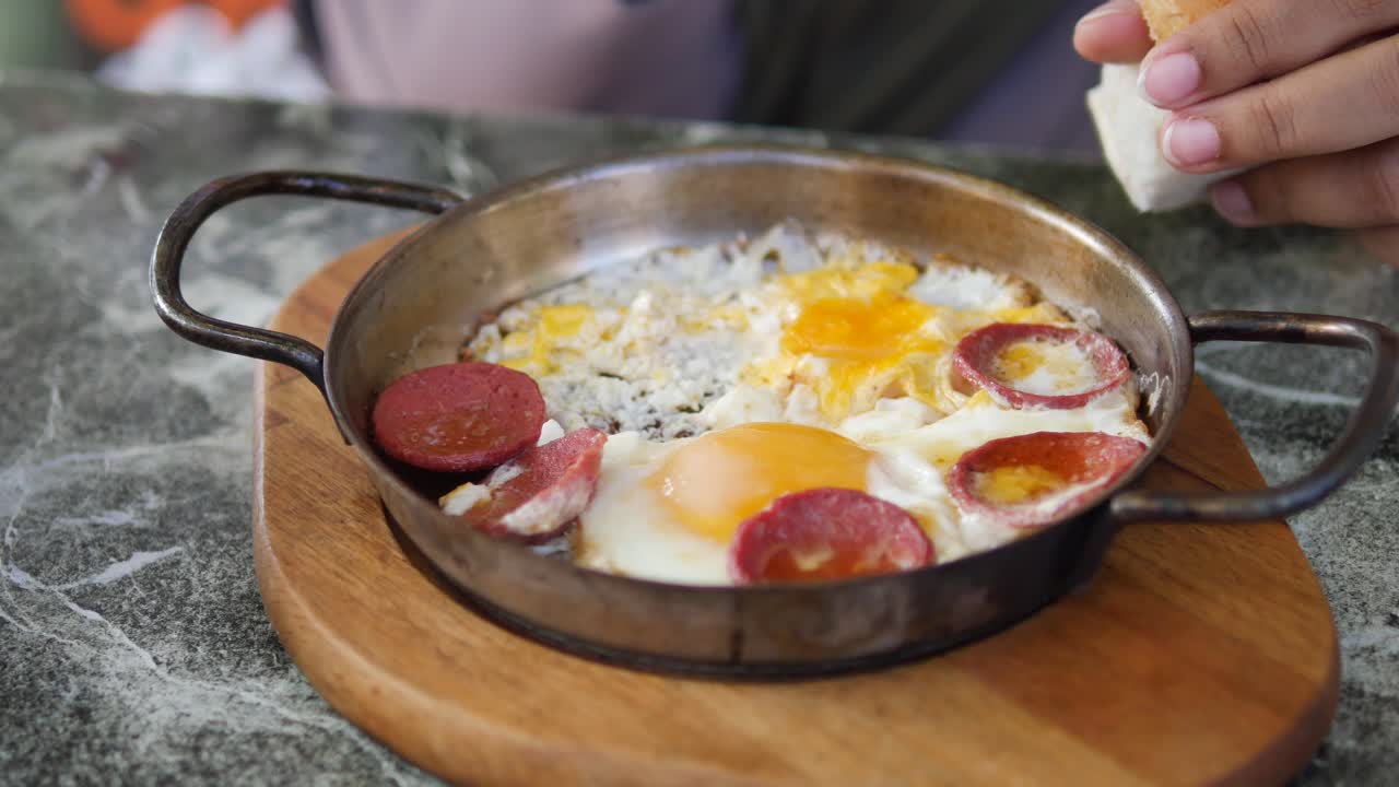 A delicious Turkish breakfast of eggs and sausage in a pan