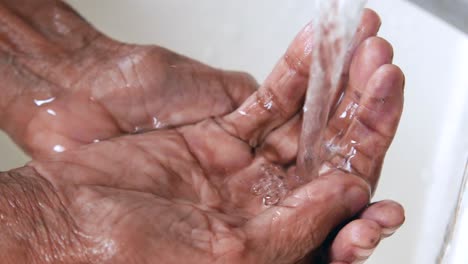 washing hands under a tap