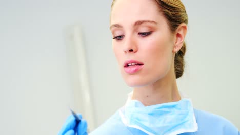 Female-nurse-looking-at-dental-tools