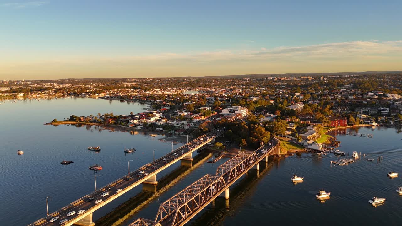 Wide aerial of Tom Uglys Bridge near Sylvania during golden hour with traffic and water below, Sydney NSW Australia