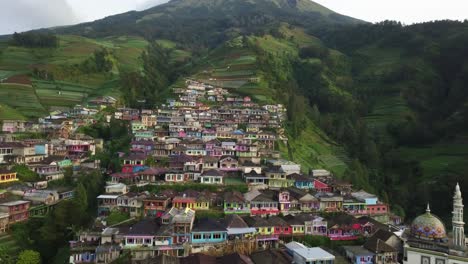 aerial panoramic view of famous nepal van java village with green mountain on the peak and multi-colored houses on slope