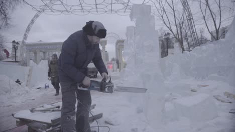 ice sculptor working on a winter ice sculpture