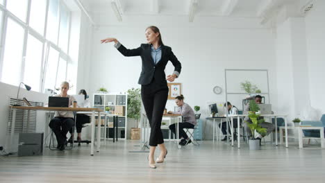 businesswoman dancing in the office