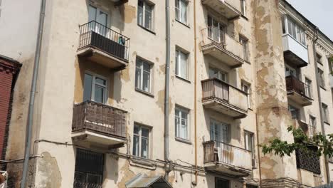 old multi-story apartment building with peeling paint