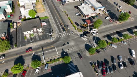 Orbiting-aerial-shot-of-an-urban-intersection-in-Anacortes,-WA