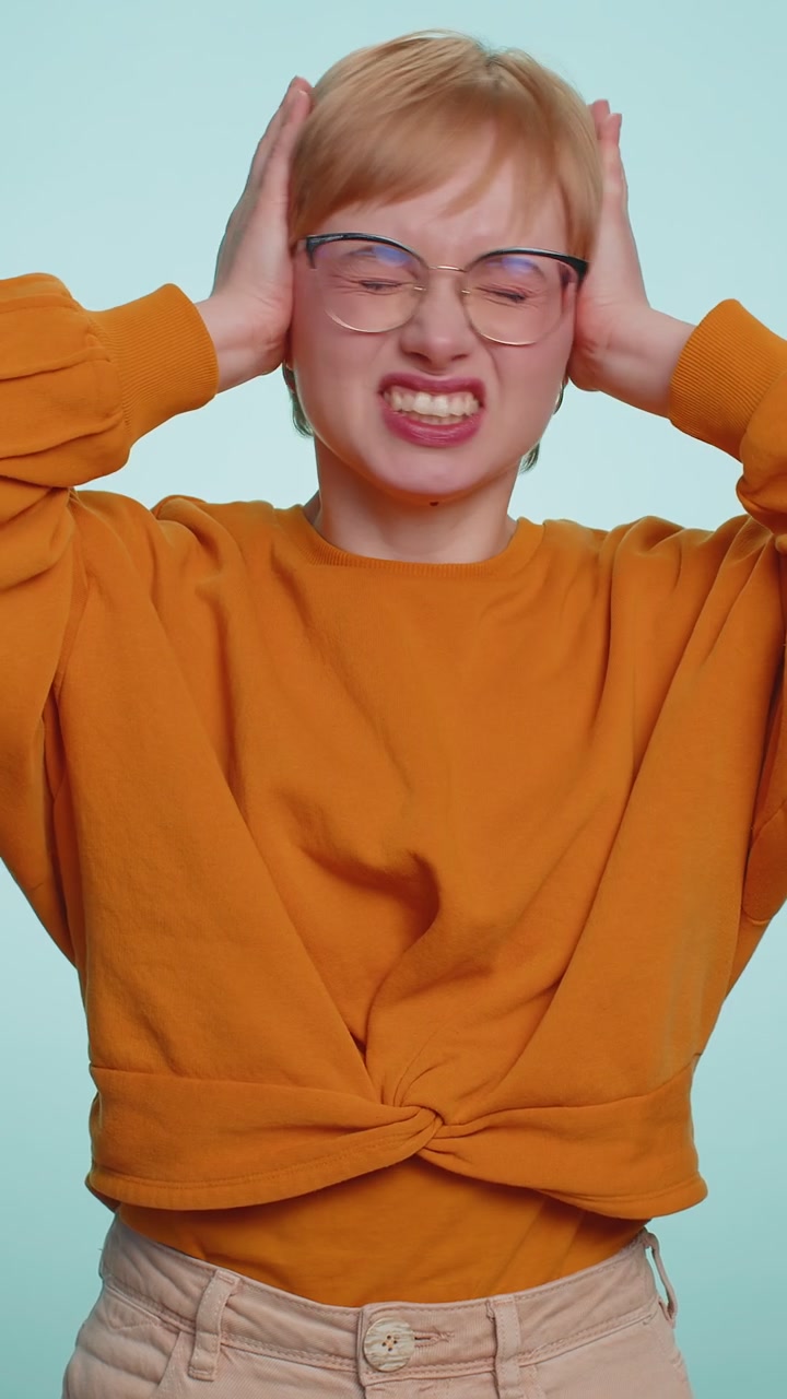 Annoyed irritated young woman covering ears gesturing no avoiding advice ignoring noise loud voices