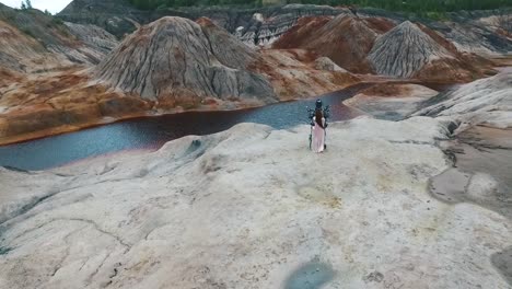 couple in fantasy armor posing in a colorful quarry landscape