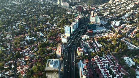 highway interstate through downtown buildings of mexico city, aerial view from above