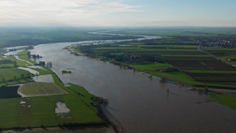 aerial wide shot of the lek river in that netherlands, that has swelled to more than five time its normal size as heavy rains inundate much of northern europe